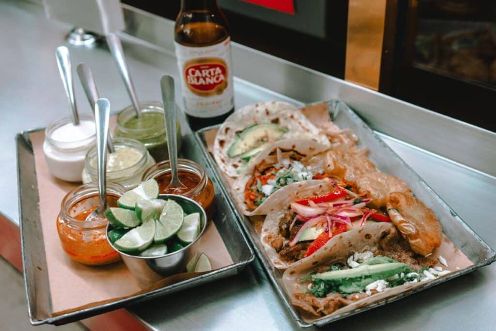 mexican shrimp burrito with a variety of salsas on the side