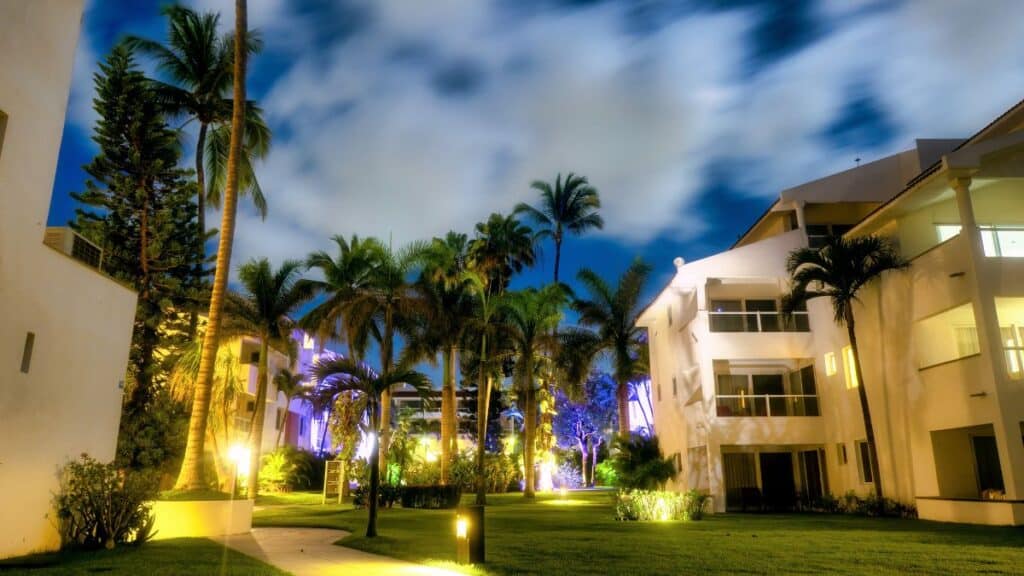 night photo of boutique hotel with palm trees