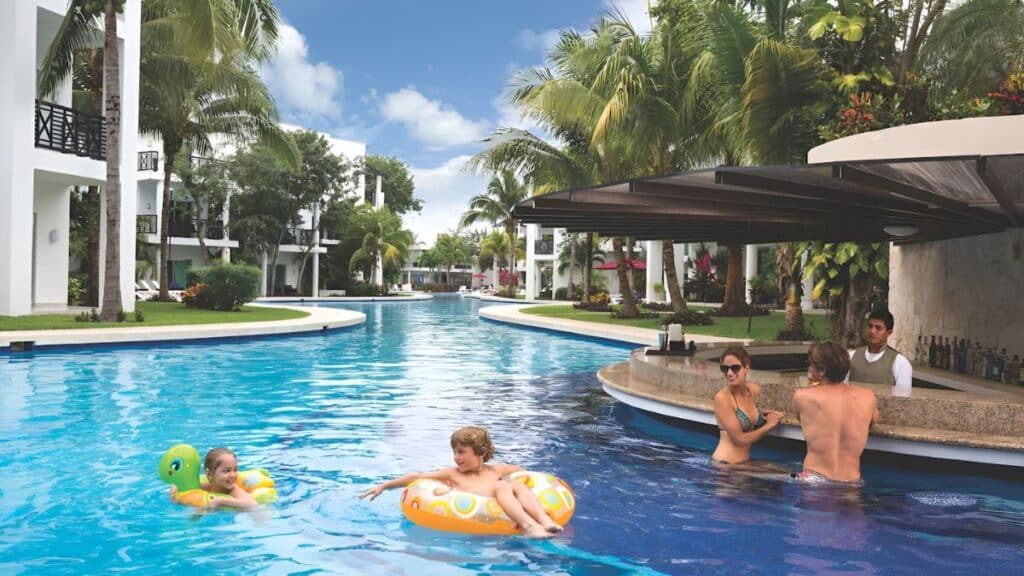 fives beach hotel parents enjoying poolside bar while watching their kids