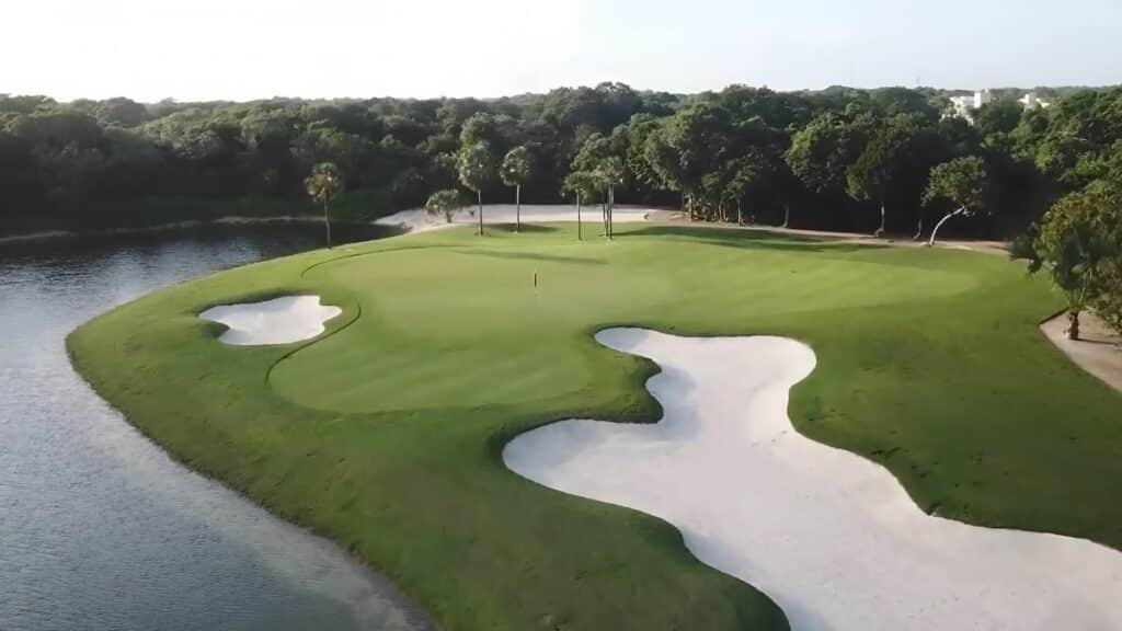 gran coyote golf aerial view of sand trap with woods in the background