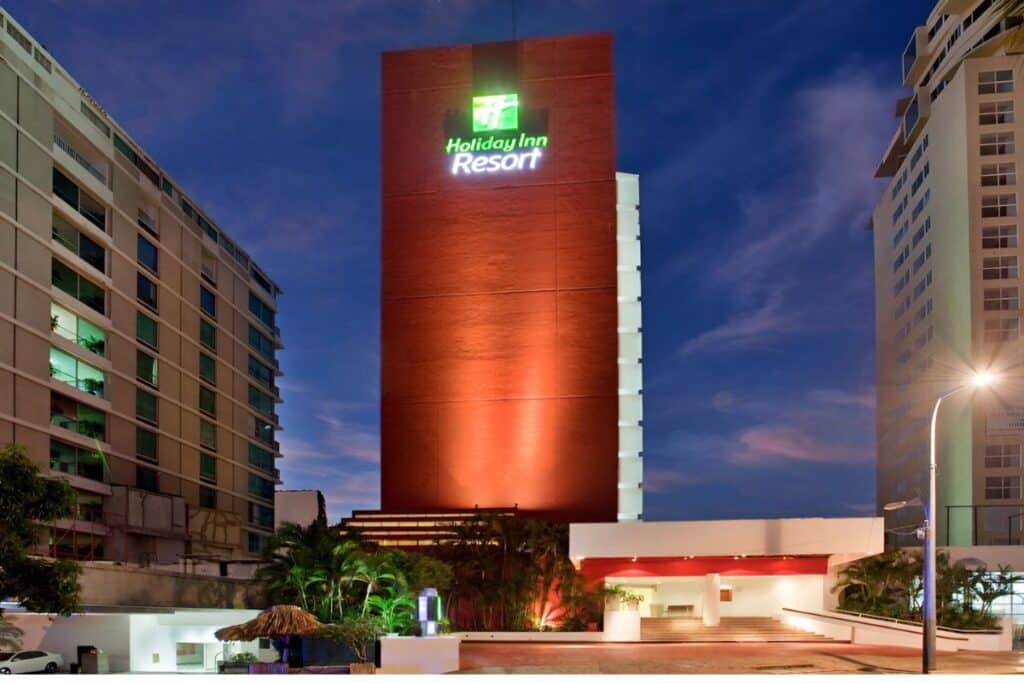 holiday inn resort acapulco twilight view lit up in the evening