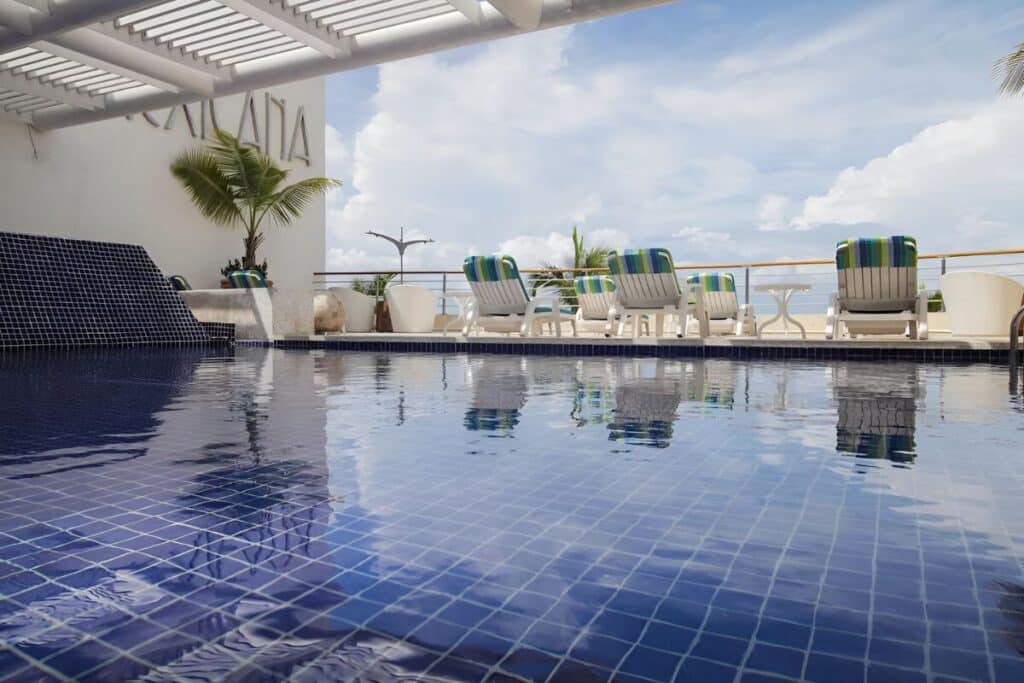 casa mexicana main entrance fountain with sun loungers