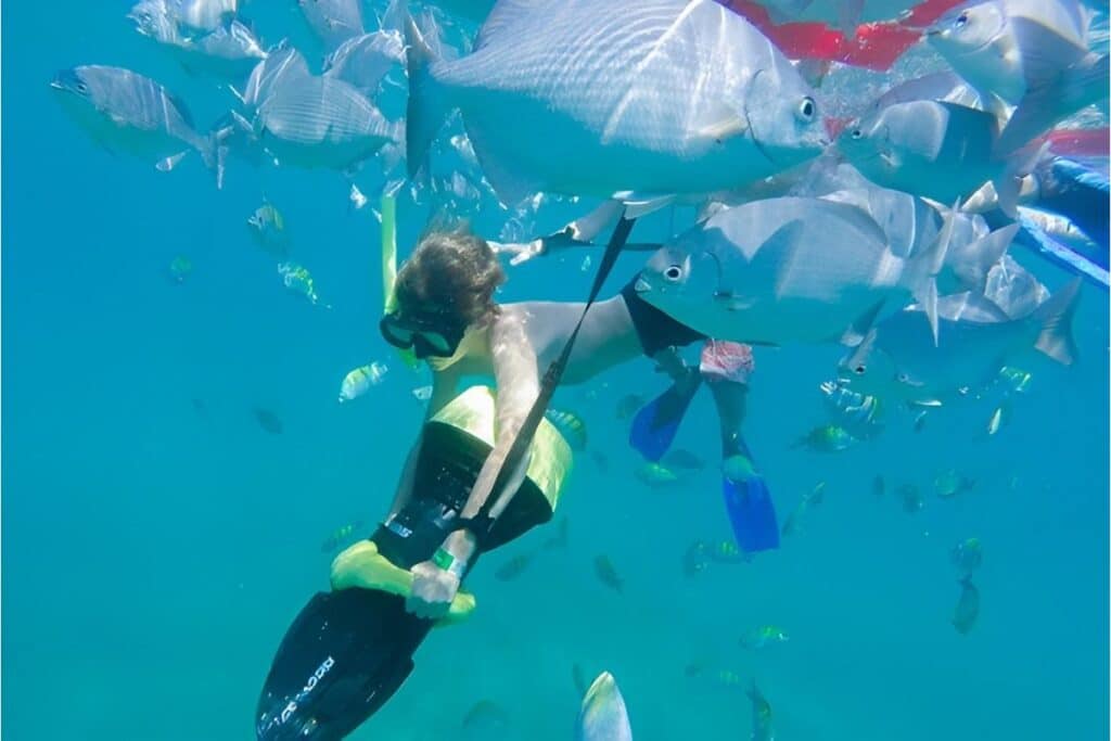 boy suing a motorized sea scooter to explore the depths