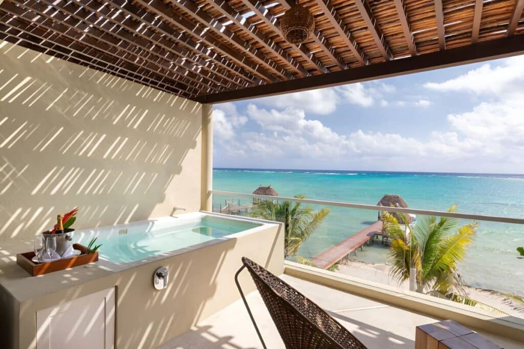master suite with plunge pool and champagne overlooking beach and personal dock