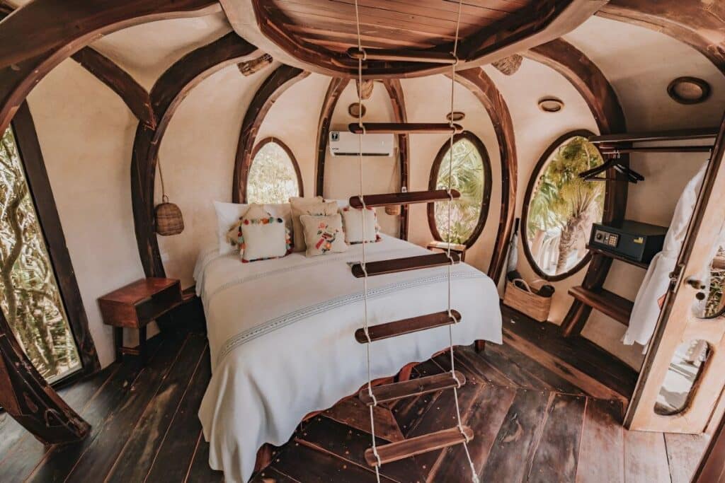 tree house master suite with rustic trimmings with rope ladder in foreground