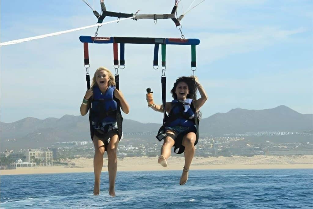 two women having an absolute thrill parasailing in the air