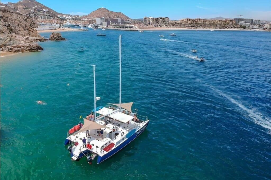 aerial view of luzury catamaran in the bay with skyline background